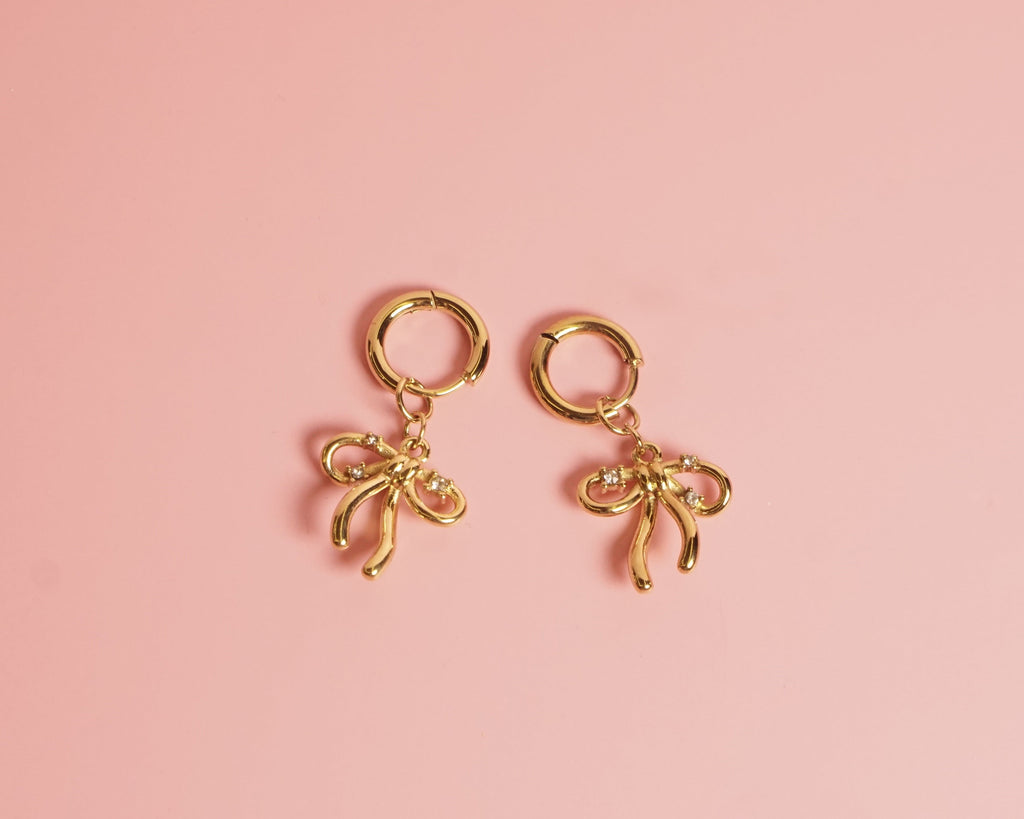 Arracada moño lazo con cristales , acero