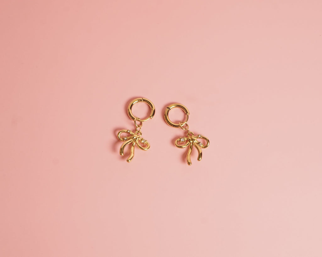 Arracada moño lazo con cristales , acero