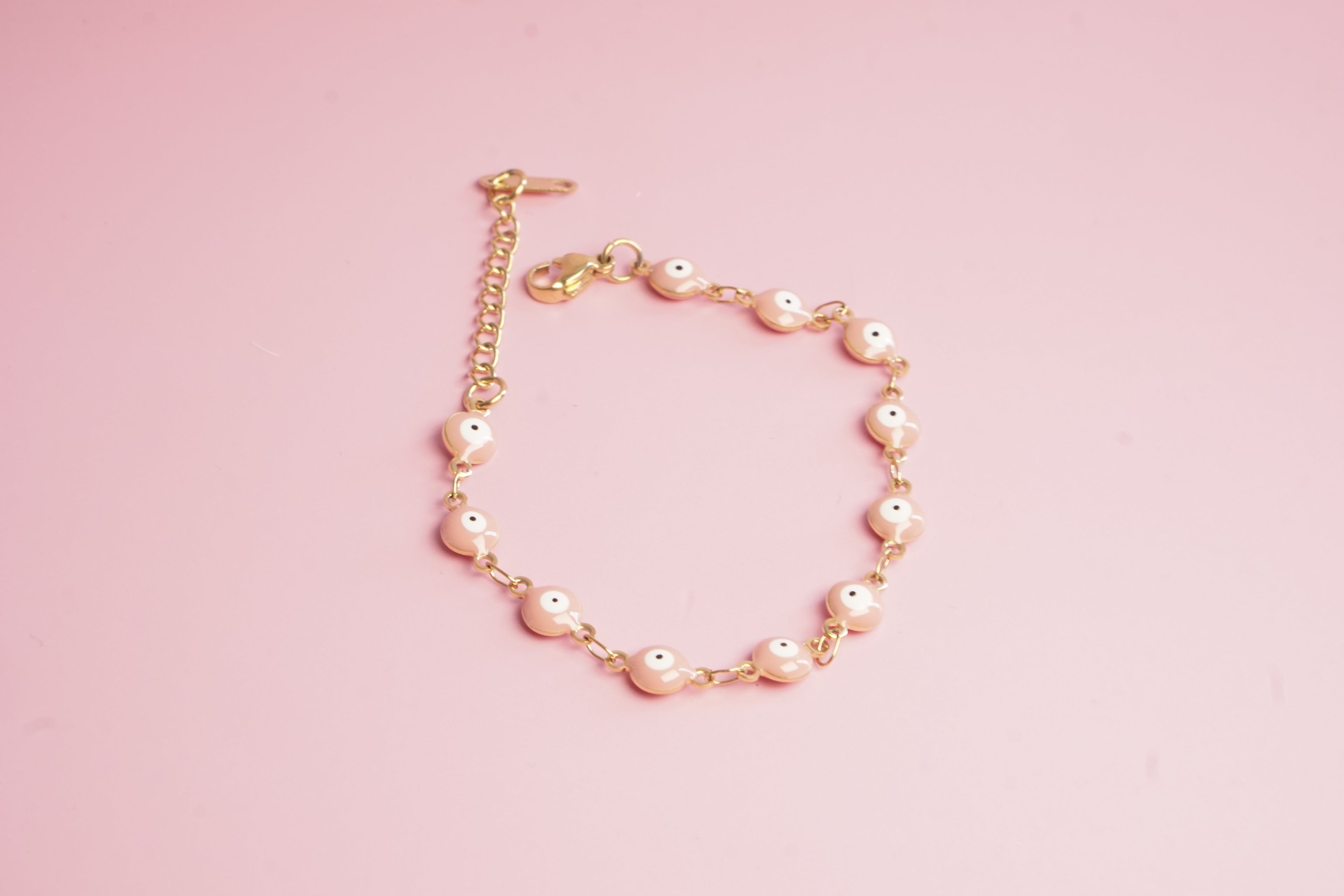 PULSERA DE OJITOS 6MM ROSA 15CM DORADO