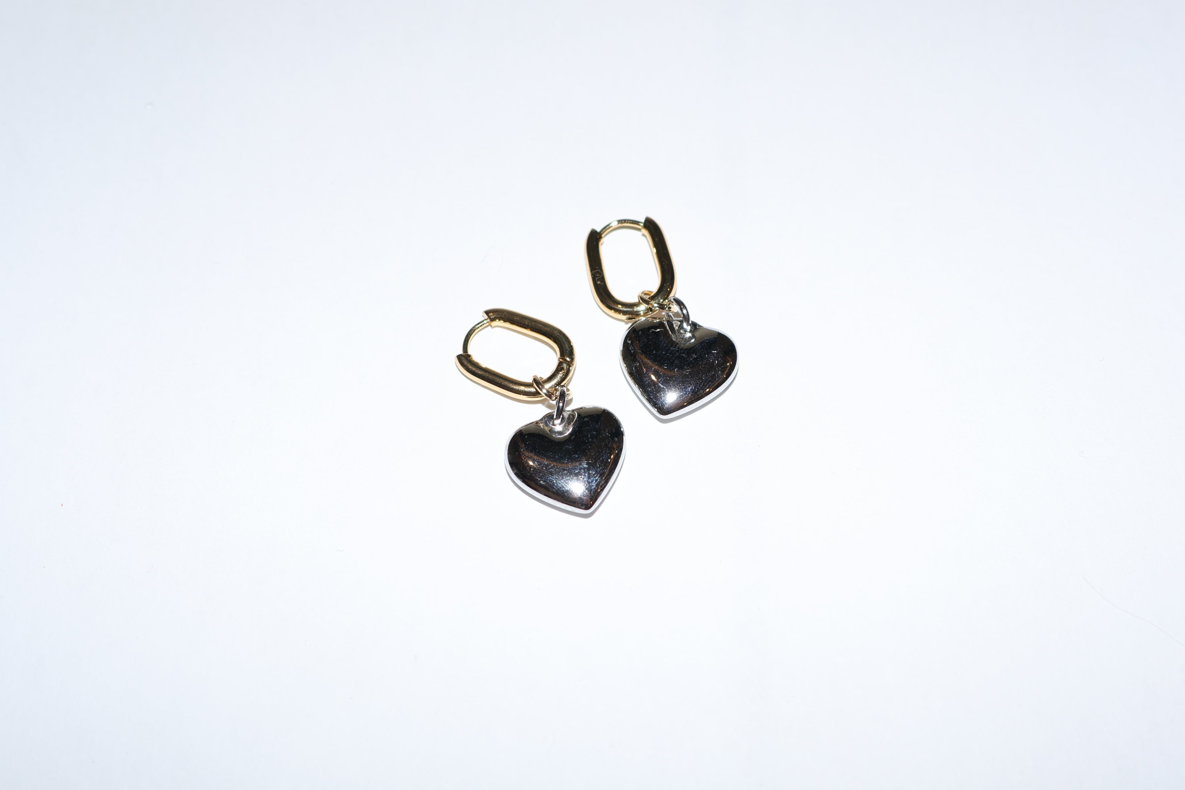 Aretes largos bicolor acero con corazon