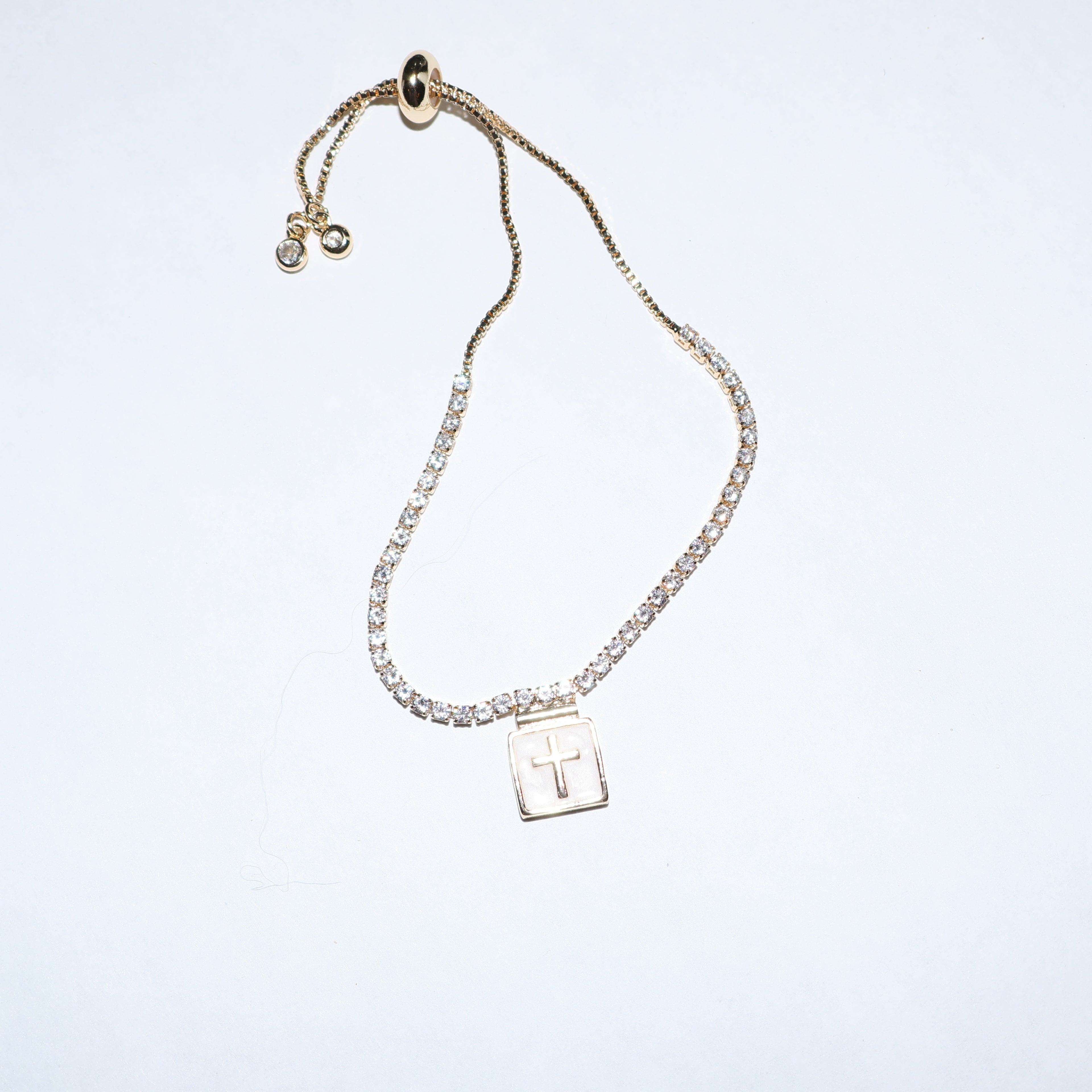 Pulsera tipo tennis con cruz
